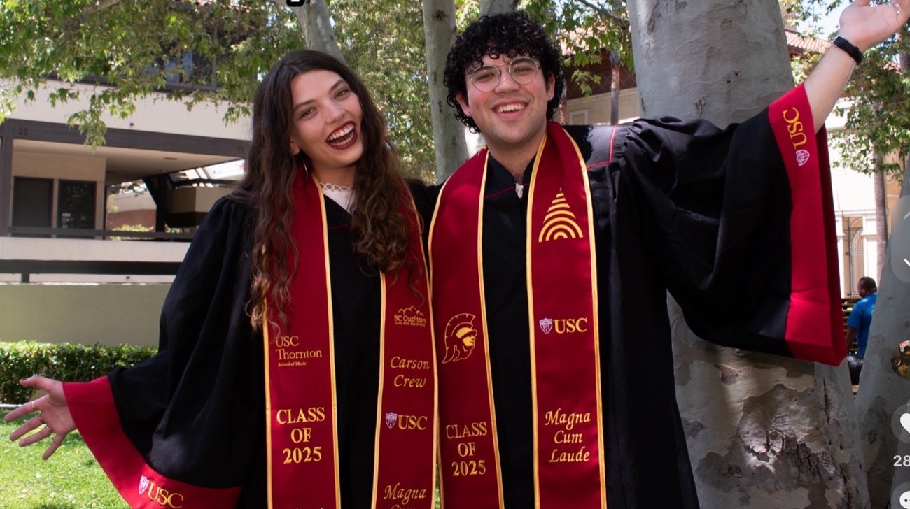 Nico Jones and Carmen Thomassiny in USC Thornton graduation regalia, Class of 2025, Magna Cum Laude
