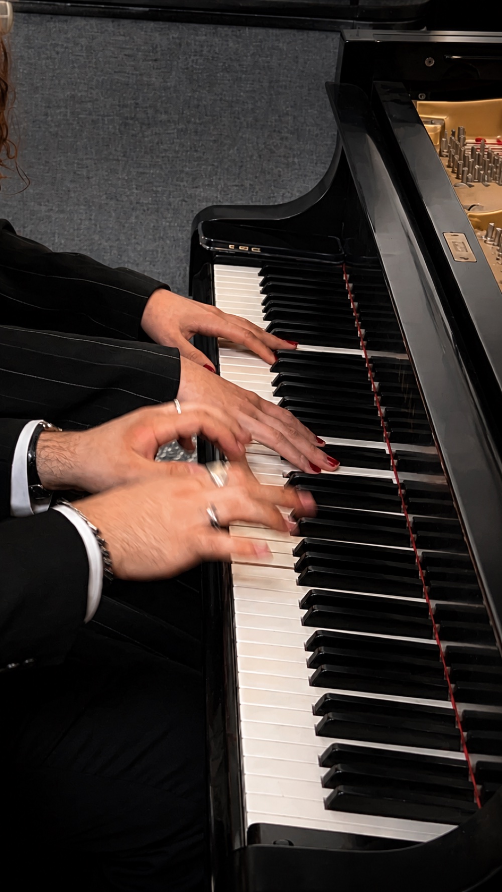 Close-up of hands playing the piano keys